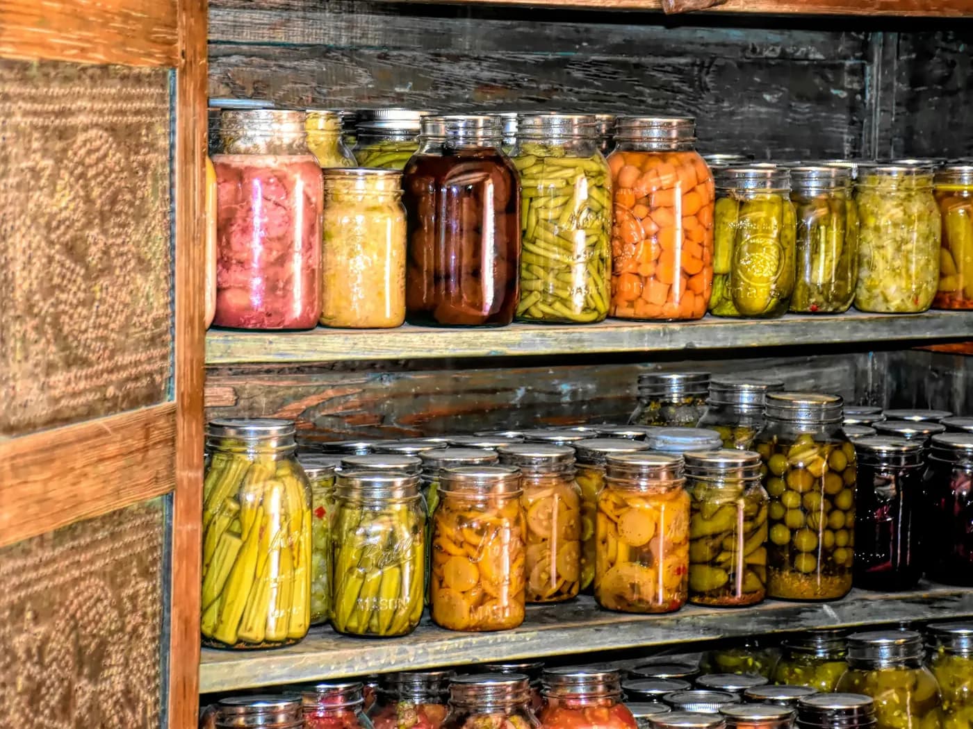 Shelves of preserved vegetables and fruit in sealed glass jars